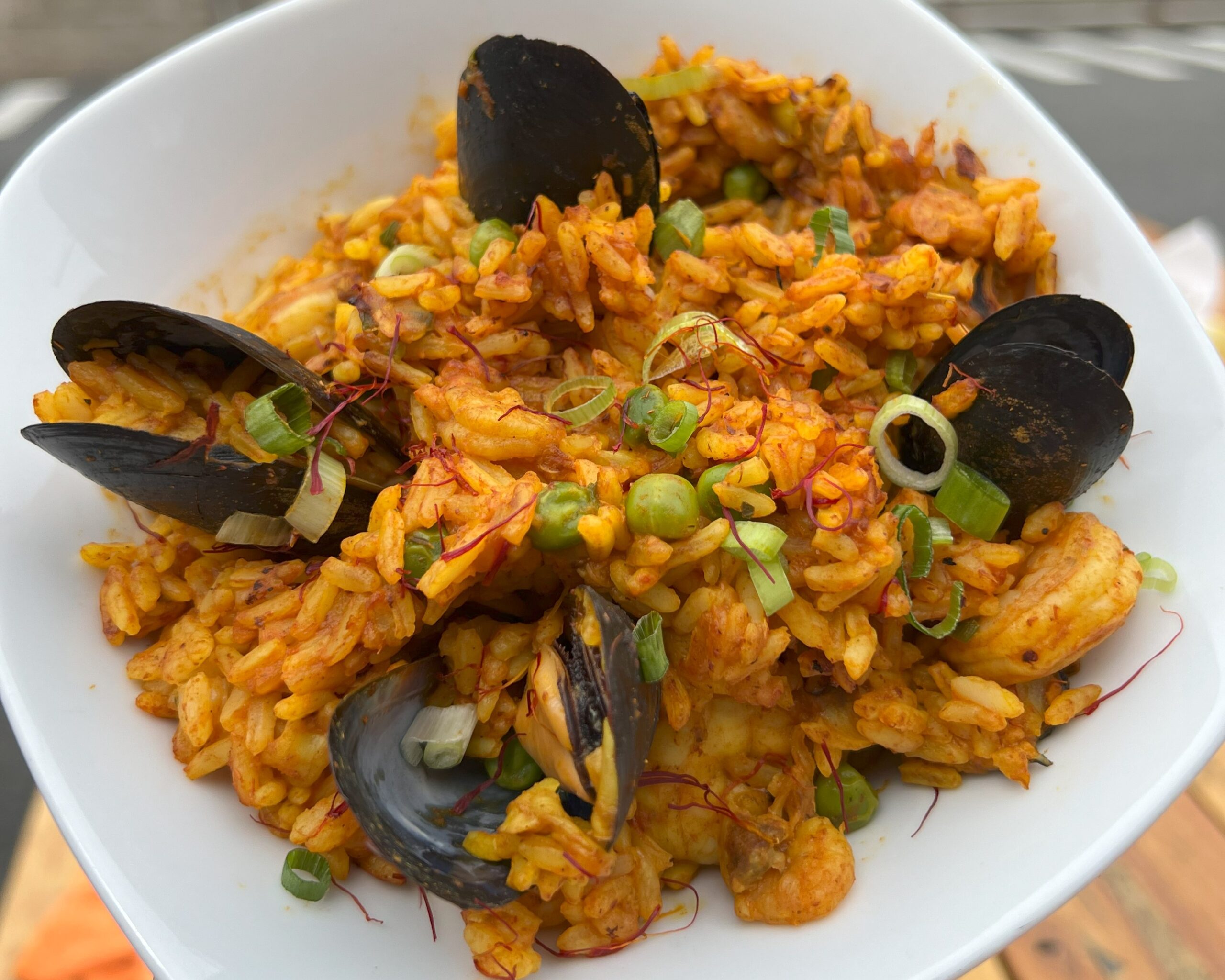 photo of gluten free seafood paella in a white bowl